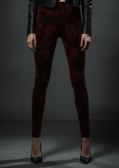 waist-down close-up, leather jacket Close-up of burgundy floral burnout velvet leggings with high waist, styled with black leather jacket

