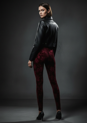 back view, model standing Back view of burgundy burnout velvet leggings on model with black leather jacket and kitten heels

