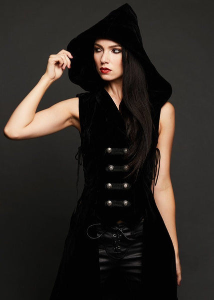 Woman wearing black velvet gothic vest with flare pants - bohemian rock style outfit