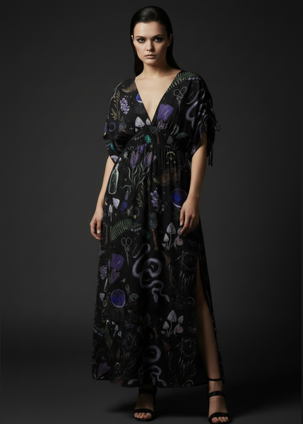 Black witchy maxi dress with mystical forest print, snakes, mushrooms, potion bottles and gothic botanical details